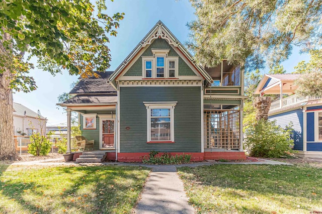 victorian house featuring a front yard