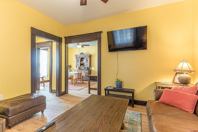 living room with ceiling fan and light hardwood / wood-style floors