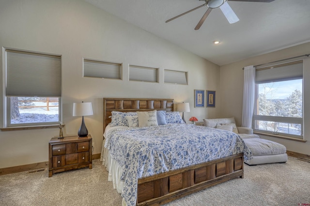 carpeted bedroom featuring multiple windows, lofted ceiling, and ceiling fan