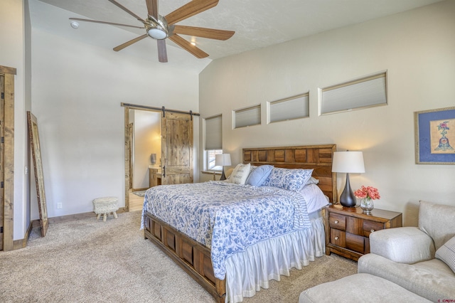 carpeted bedroom featuring high vaulted ceiling, a barn door, and ceiling fan