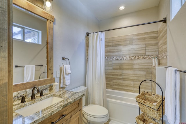 full bathroom with vanity, shower / bath combo, and toilet