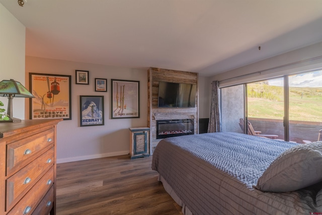 bedroom featuring dark wood-style floors, a fireplace, access to exterior, and baseboards