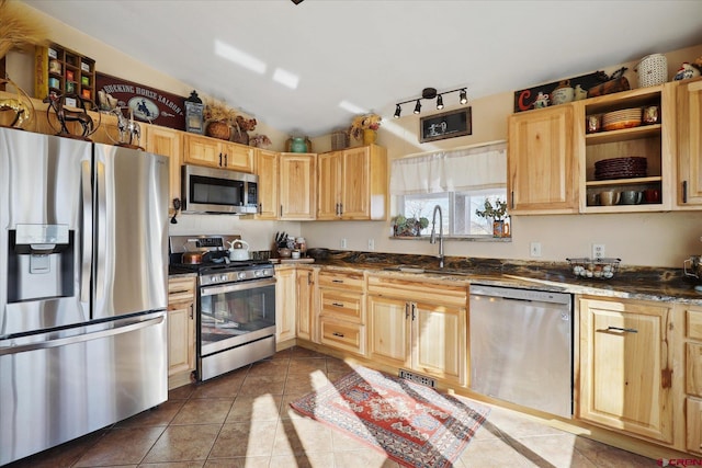 kitchen with stainless steel appliances, light brown cabinetry, and sink