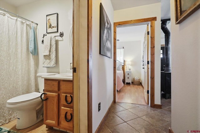 bathroom with tile patterned floors, vanity, and toilet