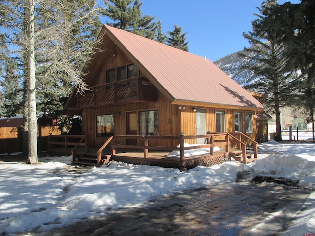 log home featuring a wooden deck