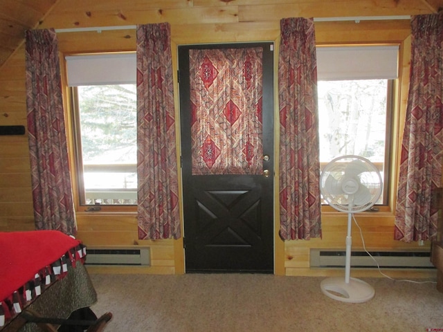 entryway featuring a baseboard radiator, plenty of natural light, and wood walls