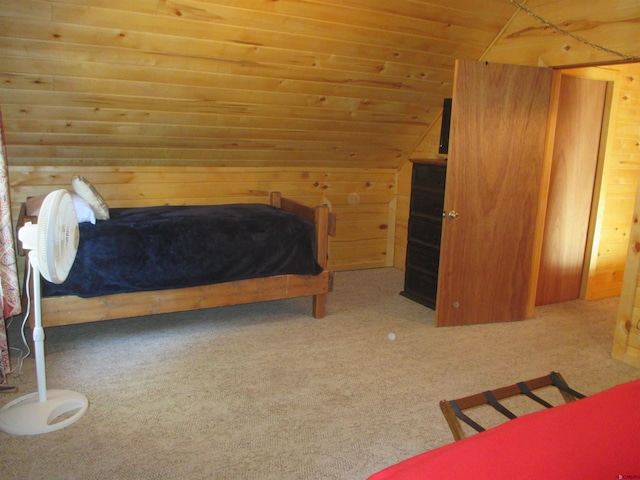 bedroom with light colored carpet, wooden ceiling, and wooden walls