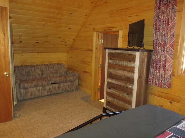 carpeted bedroom with wooden walls, vaulted ceiling, and wooden ceiling