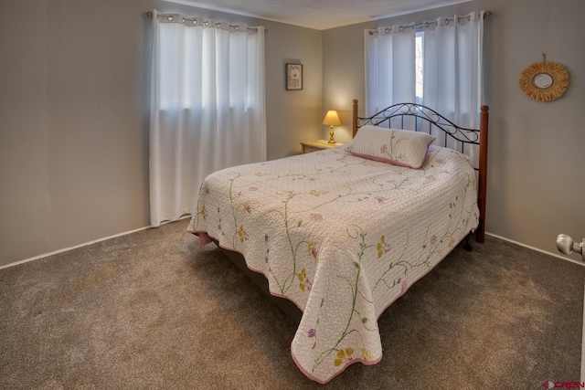 bedroom featuring dark carpet