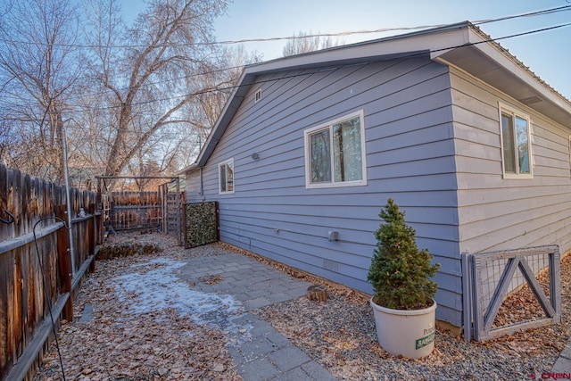 view of side of home with a patio