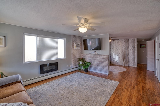 living room with ceiling fan, hardwood / wood-style flooring, a textured ceiling, and baseboard heating