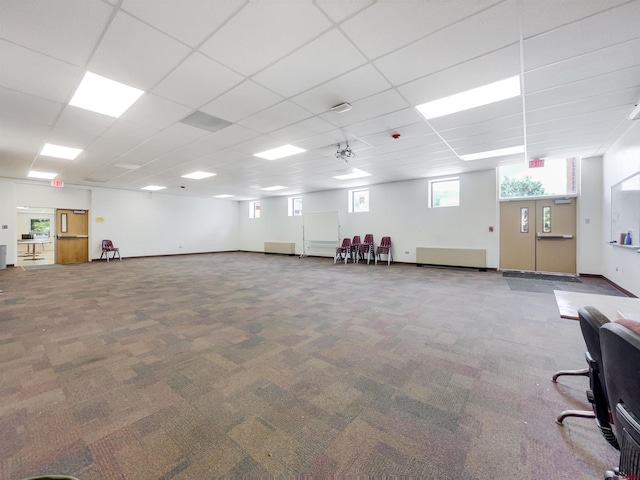 interior space with carpet floors and a paneled ceiling