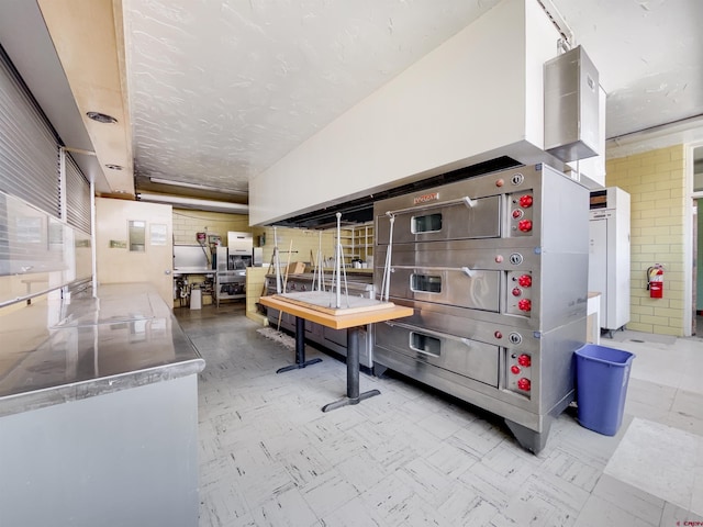 kitchen featuring stainless steel counters and white cabinets