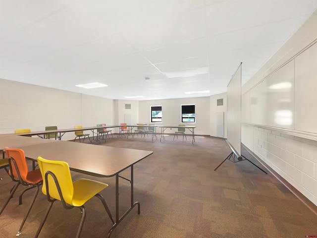 dining area featuring dark colored carpet