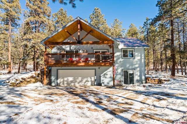 view of front of house with a garage and a deck