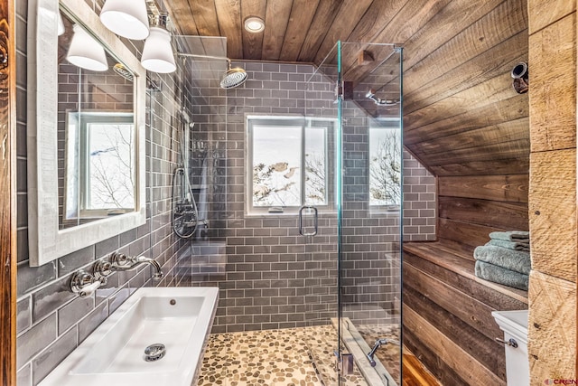 bathroom featuring sink, tile walls, wooden ceiling, and walk in shower