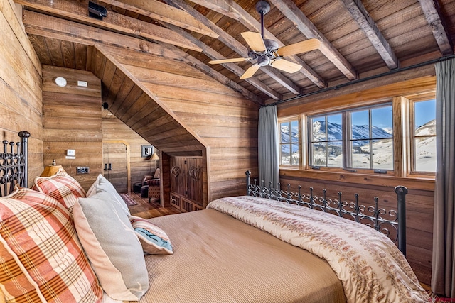 bedroom with vaulted ceiling with beams, wooden ceiling, wooden walls, a mountain view, and hardwood / wood-style floors