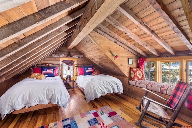 bedroom featuring hardwood / wood-style flooring, wooden ceiling, wooden walls, and vaulted ceiling with beams