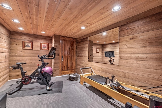 exercise room with wooden ceiling, wood walls, and carpet