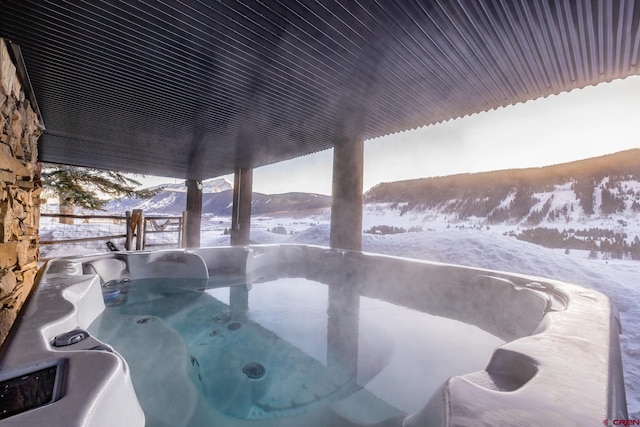 exterior space featuring a hot tub and a mountain view