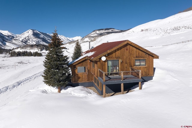 exterior space with a deck with mountain view