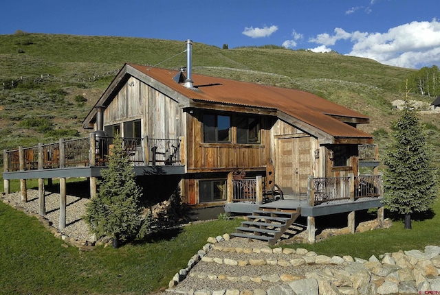 rear view of property featuring a deck