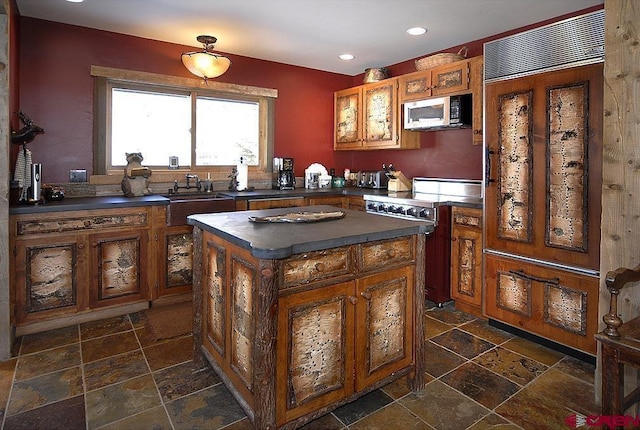 kitchen with sink, a kitchen island, and electric range