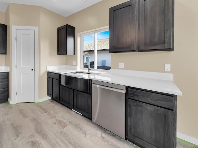 kitchen with stainless steel dishwasher, dark brown cabinetry, sink, and light hardwood / wood-style flooring