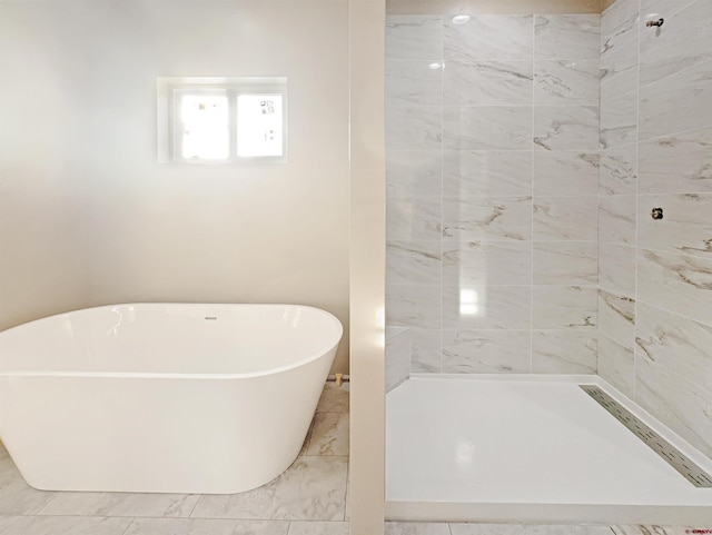 bathroom featuring shower with separate bathtub