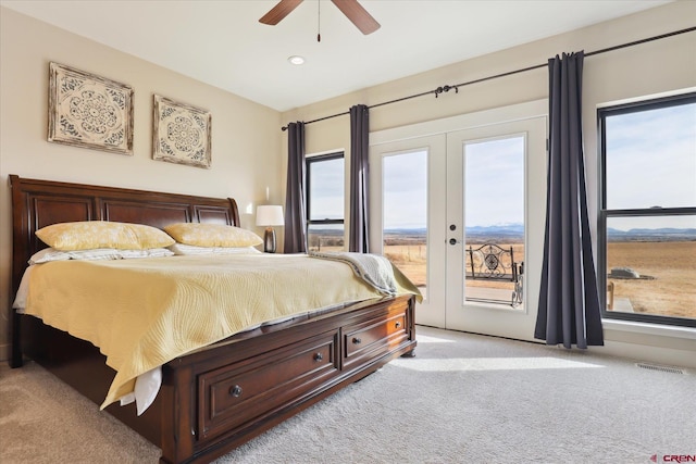 bedroom with french doors, ceiling fan, light carpet, and access to outside