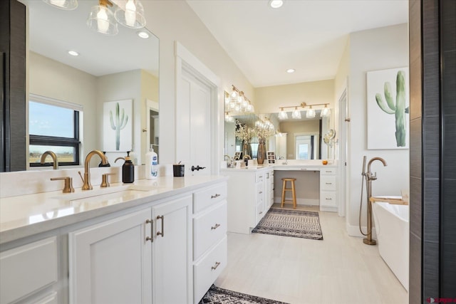 bathroom with a bathing tub and vanity