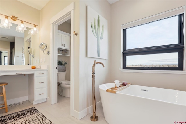 bathroom with toilet and a tub