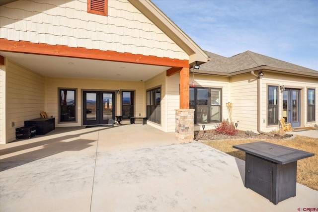 rear view of property with french doors and a patio area