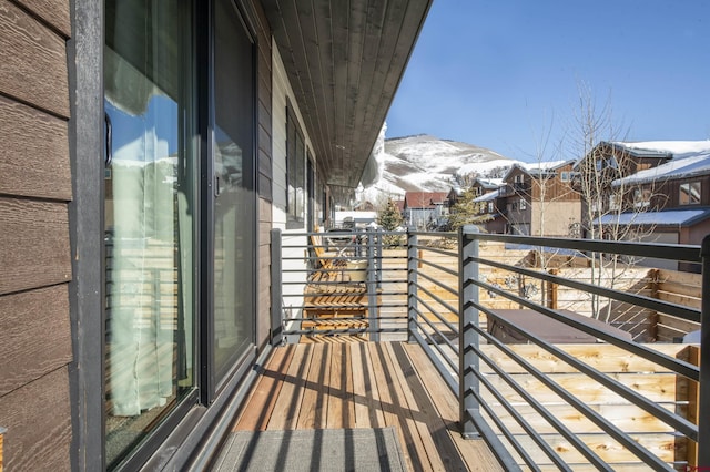 snow covered back of property with a mountain view