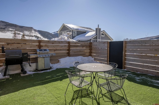 view of patio featuring a mountain view and a grill