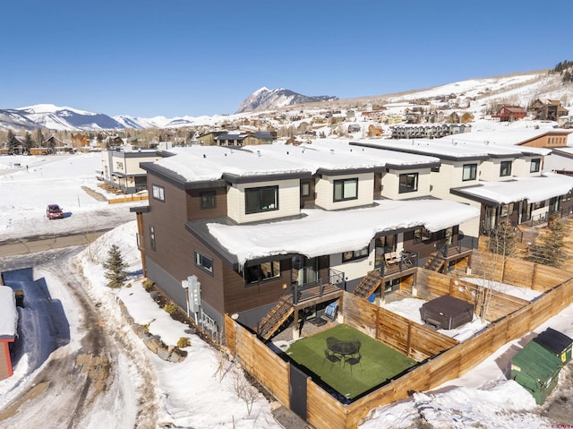 snowy aerial view with a mountain view