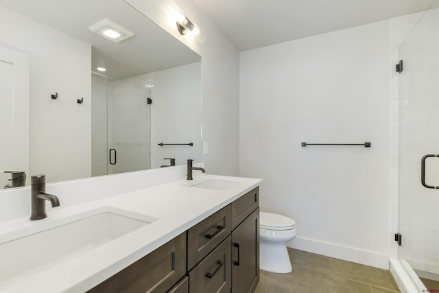 bathroom featuring vanity, toilet, and a shower with shower door