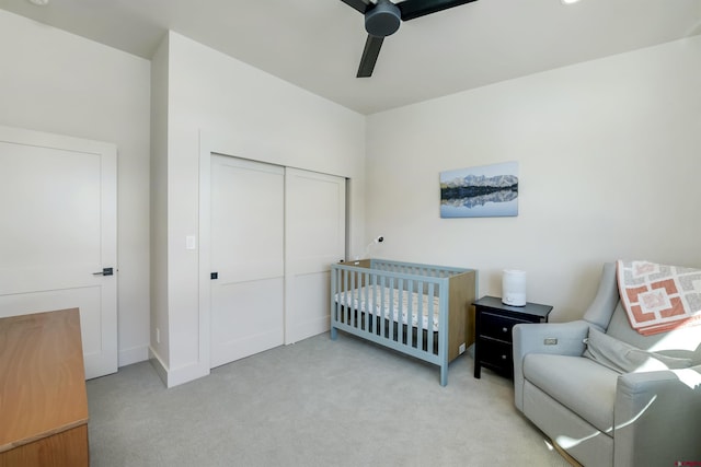 carpeted bedroom with ceiling fan and a closet