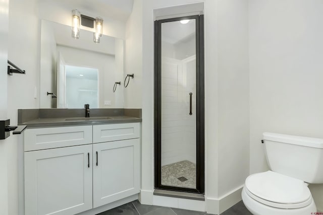 bathroom featuring vanity, toilet, and a shower with shower door