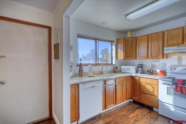 kitchen featuring sink, white appliances, and dark wood-type flooring