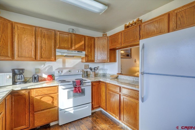 kitchen with dark hardwood / wood-style flooring and white appliances