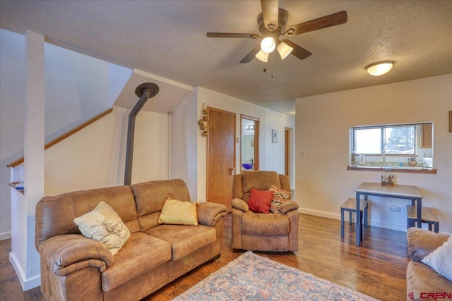 living room featuring hardwood / wood-style floors, a textured ceiling, and ceiling fan