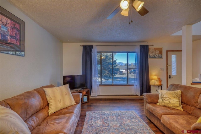 living room with ceiling fan, dark hardwood / wood-style floors, and a textured ceiling