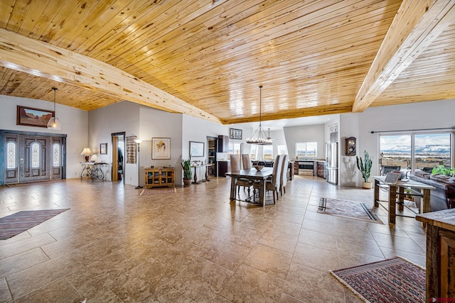 living room featuring wood ceiling, an inviting chandelier, and a high ceiling