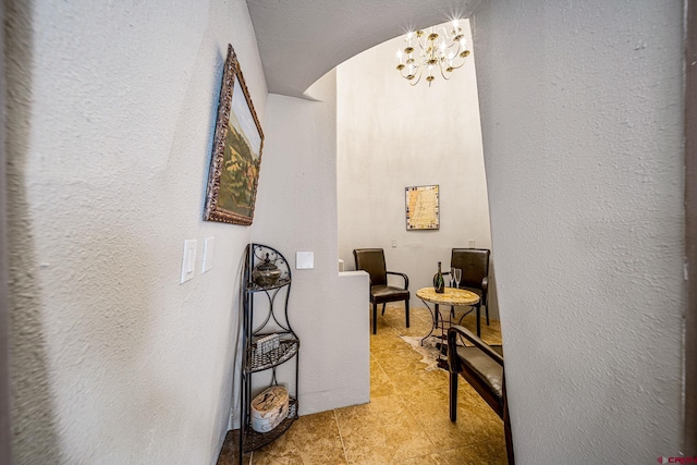 hallway with an inviting chandelier