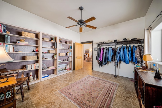 interior space featuring ceiling fan and lofted ceiling