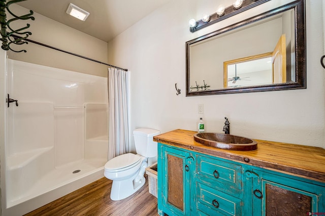 bathroom with vanity, toilet, curtained shower, and hardwood / wood-style floors