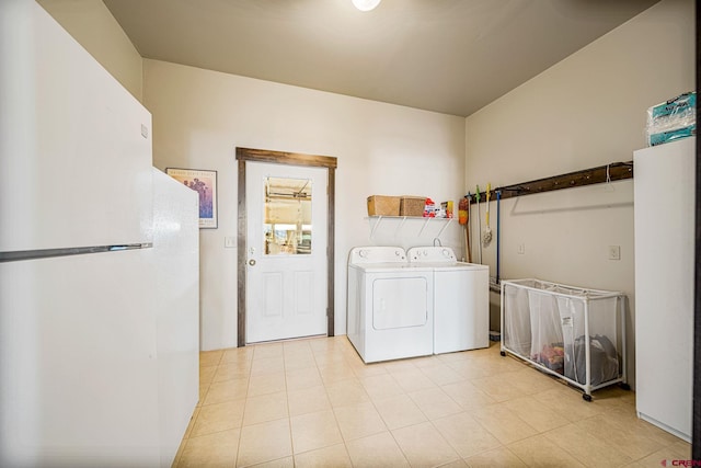 laundry area featuring separate washer and dryer and light tile patterned floors