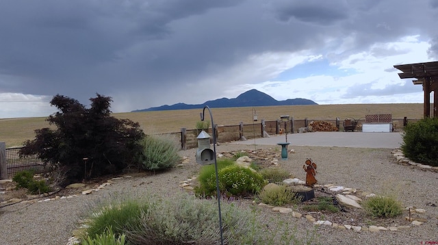 view of yard featuring a rural view and a mountain view