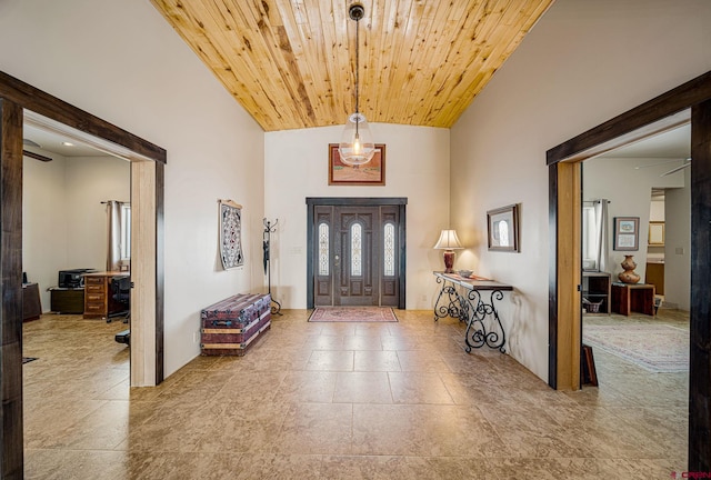 foyer entrance with wooden ceiling and high vaulted ceiling